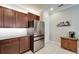 Kitchen featuring stainless steel refrigerator, granite countertops, and custom wood cabinetry at 5422 Sunset Falls Dr, Apollo Beach, FL 33572