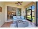 Inviting screened lanai with cozy seating area, ceiling fan, and view of landscaped backyard at 5422 Sunset Falls Dr, Apollo Beach, FL 33572