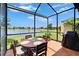 Outdoor dining on tiled lanai with a peaceful lake view, perfect for relaxed meals at 5422 Sunset Falls Dr, Apollo Beach, FL 33572