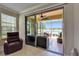 Relaxing view from sunroom to screened-in lanai, showcasing outdoor seating and tranquil water view at 5422 Sunset Falls Dr, Apollo Beach, FL 33572