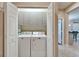 Bright laundry room featuring white washer and dryer with overhead cabinets at 5422 Sunset Falls Dr, Apollo Beach, FL 33572