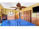 Cozy bedroom with unique ceiling fan, closet, and warm-toned walls for a comfortable retreat at 5643 86Th N Ave, Pinellas Park, FL 33782
