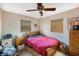 Comfortable bedroom featuring natural light from two windows with blinds and hardwood floors at 5643 86Th N Ave, Pinellas Park, FL 33782