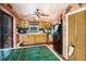 Functional kitchen with wooden cabinets, tiled countertops, and essential appliances for meal preparation and cooking at 5643 86Th N Ave, Pinellas Park, FL 33782
