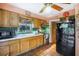 Functional kitchen with wooden cabinets, tiled countertops, and essential appliances for meal preparation and cooking at 5643 86Th N Ave, Pinellas Park, FL 33782