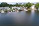 Waterfront aerial showcasing multiple docks, the calm water, and surrounding properties, highlighting the area's serene environment at 599 Westwinds Dr # 9, Palm Harbor, FL 34683