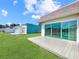 Expansive backyard featuring sliding glass doors and modern decks, seamlessly blending indoor/outdoor living at 599 Westwinds Dr # 9, Palm Harbor, FL 34683