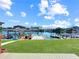 Picturesque backyard features a lush lawn, waterside dock, and beautiful water views on a sunny day at 599 Westwinds Dr # 9, Palm Harbor, FL 34683