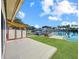 Scenic backyard view highlighting the expansive deck, waterfront access, and lush green lawn extending to the canal at 599 Westwinds Dr # 9, Palm Harbor, FL 34683