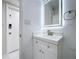 Bright bathroom featuring an illuminated mirror, a sleek vanity with modern fixtures, and fresh, neutral tones at 599 Westwinds Dr # 9, Palm Harbor, FL 34683