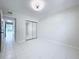 Bedroom featuring tile flooring and closet with mirrored doors for ample storage at 599 Westwinds Dr # 9, Palm Harbor, FL 34683