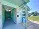 Charming entrance featuring a turquoise exterior, a covered walkway, and stone accents, offering a welcoming curb appeal at 599 Westwinds Dr # 9, Palm Harbor, FL 34683