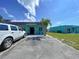 Exterior shot showing the building's facade, a well-maintained parking area, and landscaping, with a glimpse of adjacent properties at 599 Westwinds Dr # 9, Palm Harbor, FL 34683