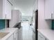 Clean kitchen boasts white cabinets, stainless appliances, and in-unit laundry, flowing to outdoors at 599 Westwinds Dr # 9, Palm Harbor, FL 34683