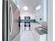 Charming kitchen with stainless steel appliances, stylish backsplash, and washer-dryer combo at 599 Westwinds Dr # 9, Palm Harbor, FL 34683