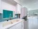 Bright kitchen with white cabinets, modern countertops, and views of the water at 599 Westwinds Dr # 9, Palm Harbor, FL 34683