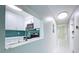 Bright kitchen with white cabinets, stainless steel appliances and backsplash accents, connected to a hallway at 599 Westwinds Dr # 9, Palm Harbor, FL 34683