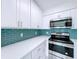 The kitchen is updated with stainless steel appliances and white cabinets, offering a sleek design at 599 Westwinds Dr # 9, Palm Harbor, FL 34683
