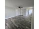 This large bedroom features three closets, a ceiling fan, and hardwood floors at 6008 Firefly Ln, Apollo Beach, FL 33572
