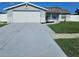 Charming single-story home featuring a well-manicured lawn and attached garage at 6008 Firefly Ln, Apollo Beach, FL 33572