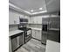 Updated kitchen featuring stainless steel appliances and light grey cabinets at 6008 Firefly Ln, Apollo Beach, FL 33572
