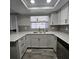 Updated kitchen featuring stainless steel appliances and light grey cabinets at 6008 Firefly Ln, Apollo Beach, FL 33572