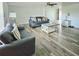 Spacious living room with modern sofas, wood-look flooring, and abundant natural light at 6008 Firefly Ln, Apollo Beach, FL 33572