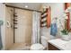 Updated bathroom with a shower head, decorative patterned shower curtain, and towel storage shelf at 630 Mac Crillus Rd, Largo, FL 33770