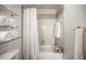 Bathroom with a shower-tub combination featuring decorative tile work and a white shower curtain at 630 Mac Crillus Rd, Largo, FL 33770