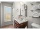 Updated bathroom with a marble vanity top, bright lighting, and stylish decorative touches at 630 Mac Crillus Rd, Largo, FL 33770