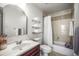Cozy bathroom with a marble vanity, decorative mirror, and a shower-tub combination at 630 Mac Crillus Rd, Largo, FL 33770