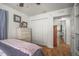 Comfortable bedroom with wood floors, closet, dresser, and an open doorway to the en-suite bathroom at 630 Mac Crillus Rd, Largo, FL 33770