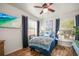 Inviting bedroom with wood floors, large windows, and a flatscreen TV for added entertainment at 630 Mac Crillus Rd, Largo, FL 33770