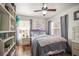 Charming bedroom with two windows, wood floors, and a ceiling fan for added comfort at 630 Mac Crillus Rd, Largo, FL 33770