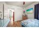 Lovely bedroom featuring wood floors, a flatscreen television, a built in closet, and access to an en-suite bathroom at 630 Mac Crillus Rd, Largo, FL 33770