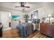 Stylish bedroom featuring hardwood floors, a ceiling fan, and ample closet space at 630 Mac Crillus Rd, Largo, FL 33770