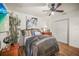 Cozy bedroom with hardwood floors, a ceiling fan, and a large closet for ample storage at 630 Mac Crillus Rd, Largo, FL 33770