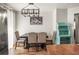 Traditional dining room with wood floors, modern light fixture, and seating for four at 630 Mac Crillus Rd, Largo, FL 33770