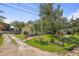 A cozy home with well-maintained lawn, driveway, a mailbox, and complemented by lush trees, creating a serene environment at 630 Mac Crillus Rd, Largo, FL 33770