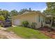 Charming home featuring a single-car garage, well-manicured lawn, and blue shutters adding a touch of elegance to the exterior at 630 Mac Crillus Rd, Largo, FL 33770
