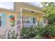 Inviting front porch with turquoise shutters, colorful seahorse decor and a cozy sitting area at 630 Mac Crillus Rd, Largo, FL 33770