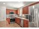 Well-equipped kitchen features stainless steel appliances, warm wood cabinets, and ample counter space at 630 Mac Crillus Rd, Largo, FL 33770
