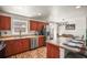Open kitchen with stainless steel appliances and wood cabinets is conveniently adjacent to the dining area at 630 Mac Crillus Rd, Largo, FL 33770