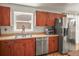Efficient kitchen offers stainless steel appliances and warm wood cabinets, complemented by great natural light at 630 Mac Crillus Rd, Largo, FL 33770