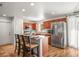 Bright kitchen features stainless steel appliances, custom wood cabinets and a breakfast bar with seating at 630 Mac Crillus Rd, Largo, FL 33770