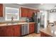 Well-equipped kitchen with stainless steel appliances, warm wood cabinets, and ample counter space at 630 Mac Crillus Rd, Largo, FL 33770