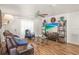 Inviting living room with wood floors, fan, and a comfortable seating arrangement with natural light at 630 Mac Crillus Rd, Largo, FL 33770