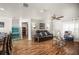 Spacious open floor plan with hardwood floors and a dining area, with neutral wall and drapery colors at 630 Mac Crillus Rd, Largo, FL 33770