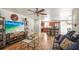 Open-concept living area with wood floors seamlessly flowing into a kitchen with bar seating at 630 Mac Crillus Rd, Largo, FL 33770