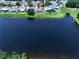 Aerial view of a single Gathering home surrounded by lush greenery and a pond at 6314 Gondola Dr, Riverview, FL 33578